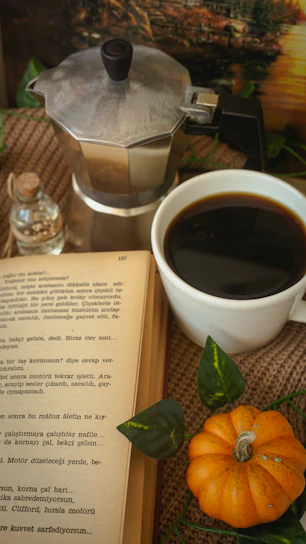 A cozy kitchen scene with a steaming cup of coffee next to an open Turfscape coffee box.