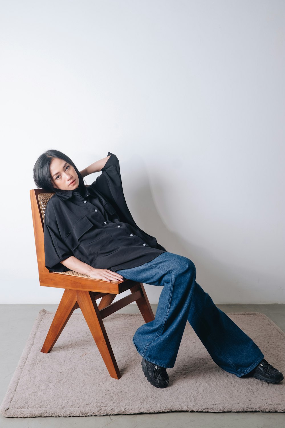 a woman sitting on a chair with her legs crossed