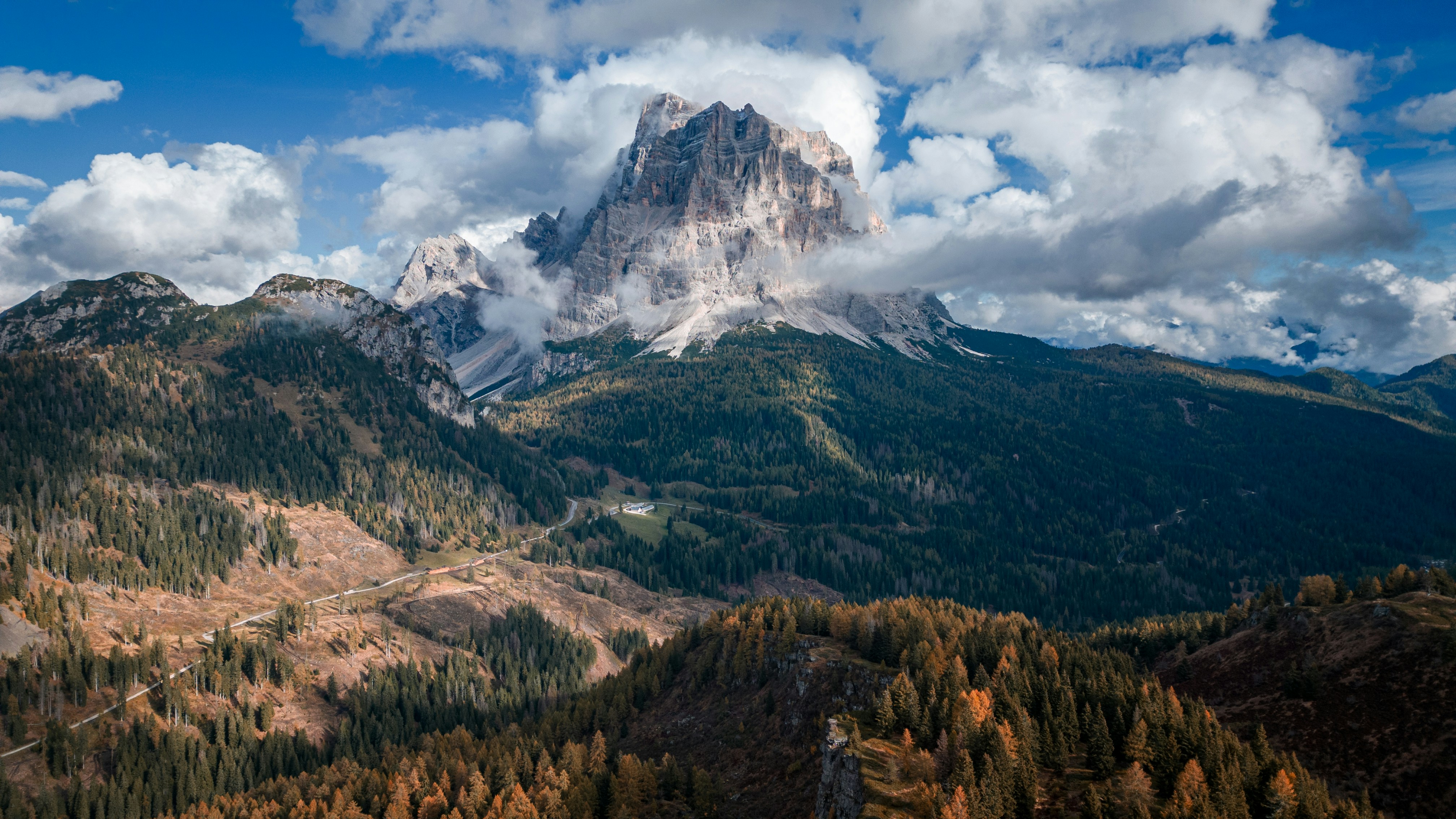 a view of a mountain range with trees in the foreground