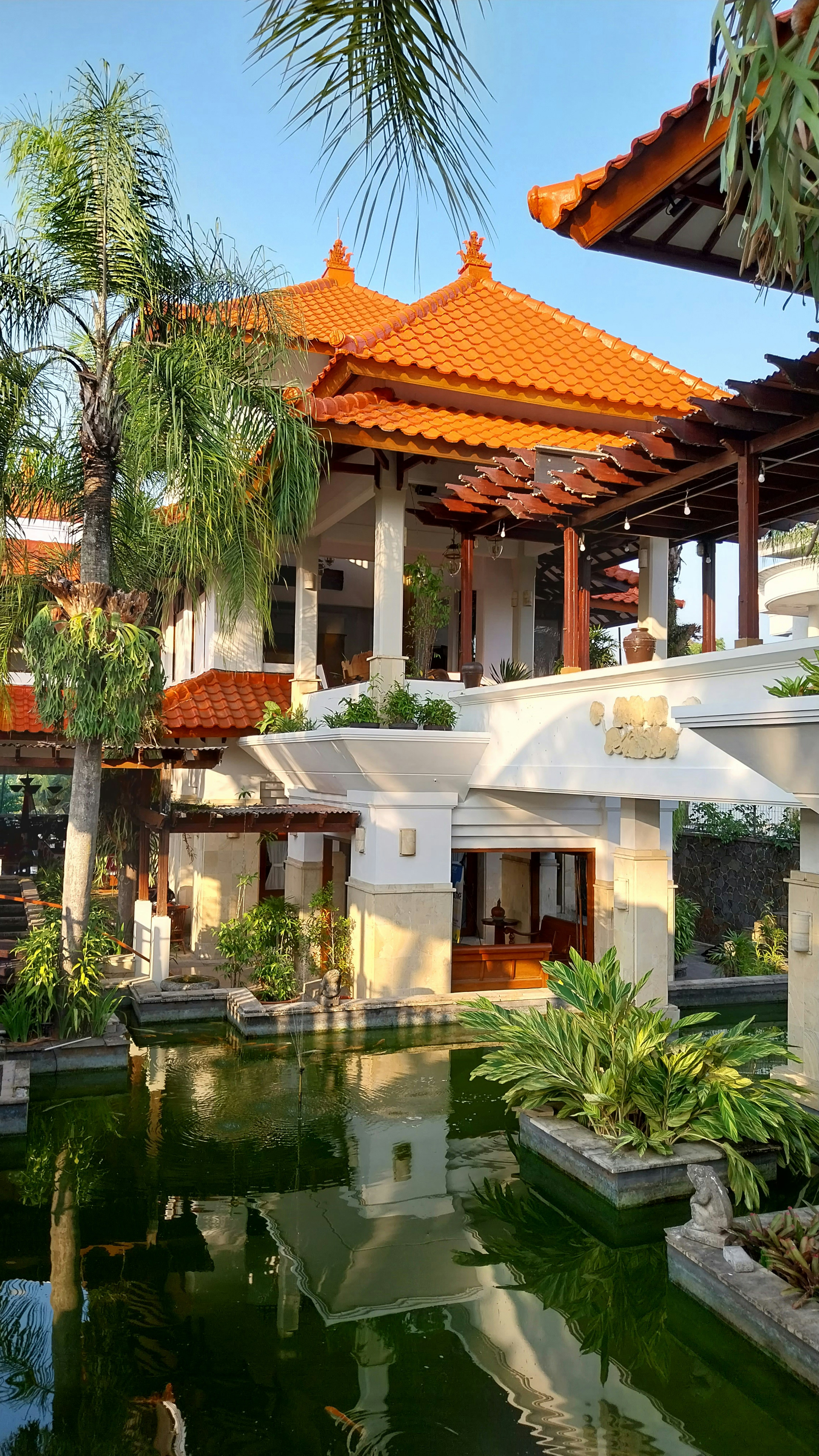 a building with a pond in front of it