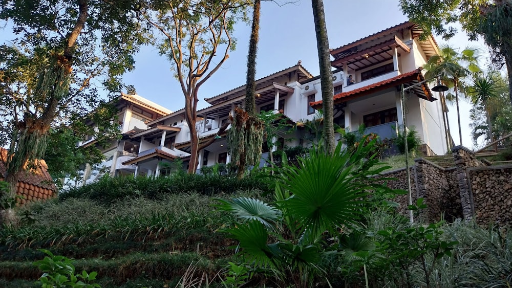 a large building with many windows and trees in front of it