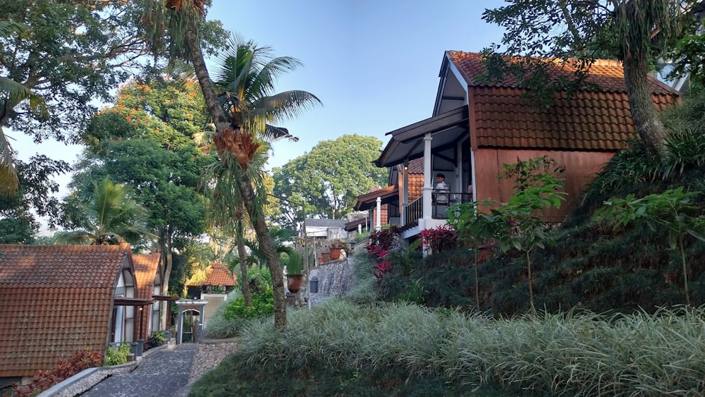 a house on the side of a hill surrounded by trees