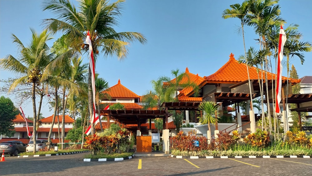 a building with a lot of palm trees in front of it