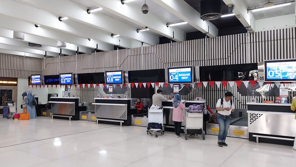 a group of people waiting in line at an airport