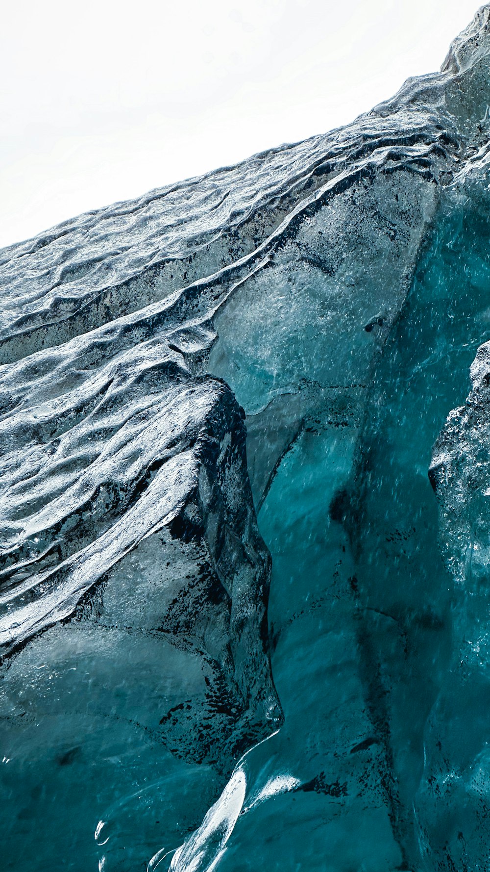 a large iceberg floating on top of a body of water