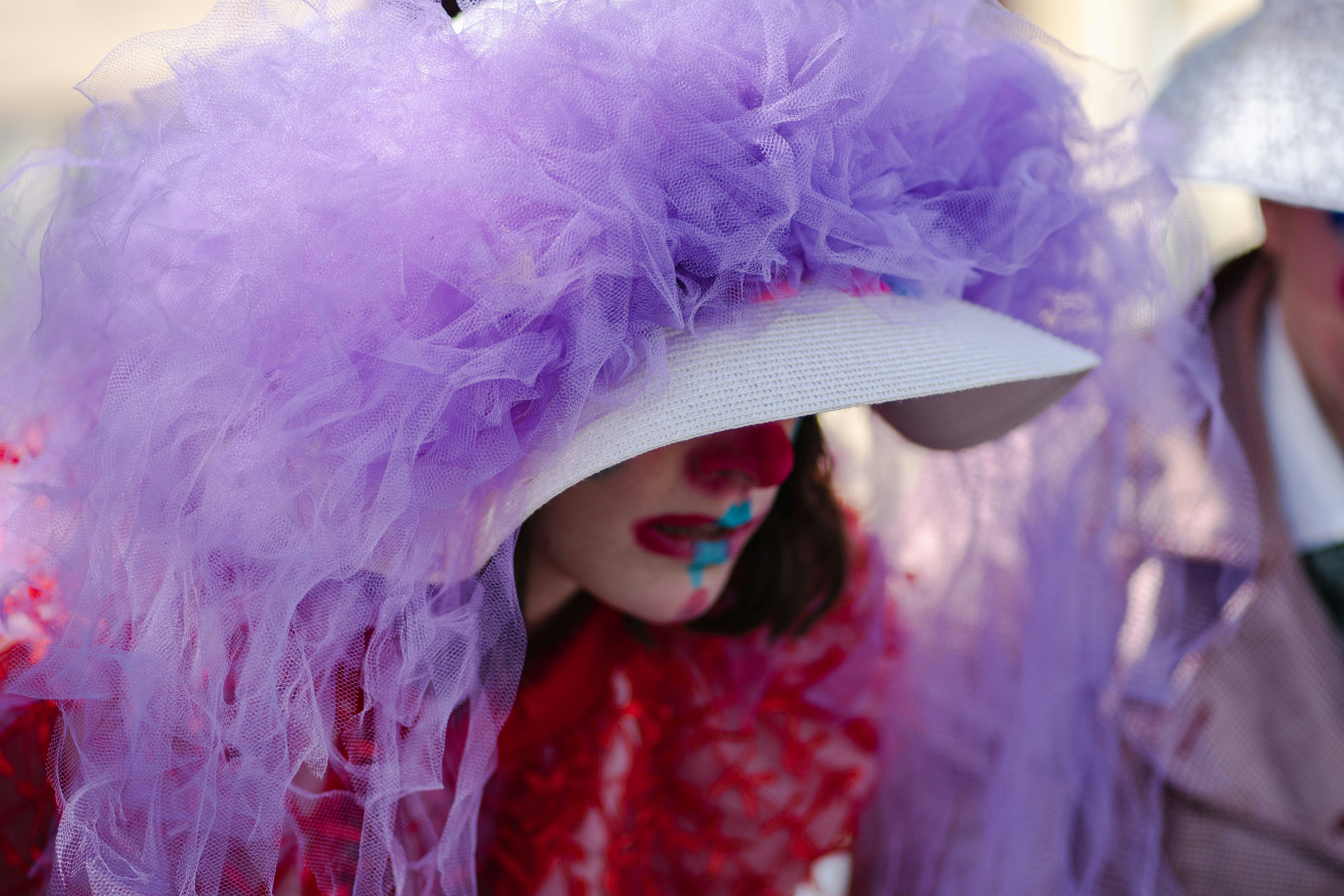 a close up of a person wearing a purple hat