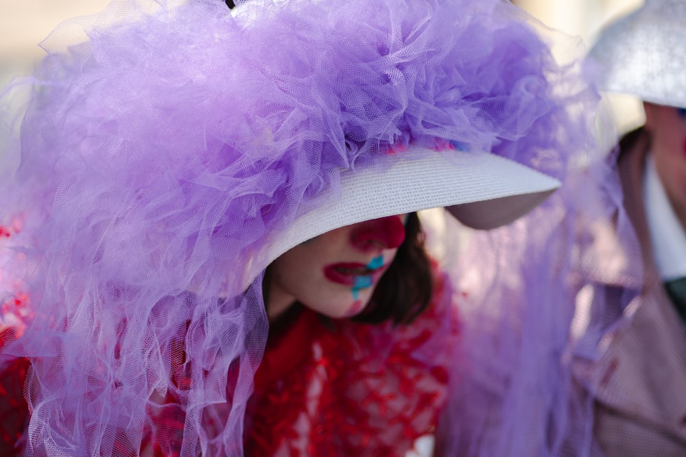 a close up of a person wearing a purple hat