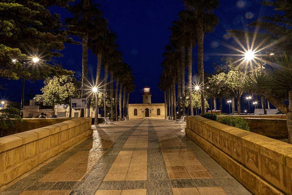 a walkway with a clock tower in the background