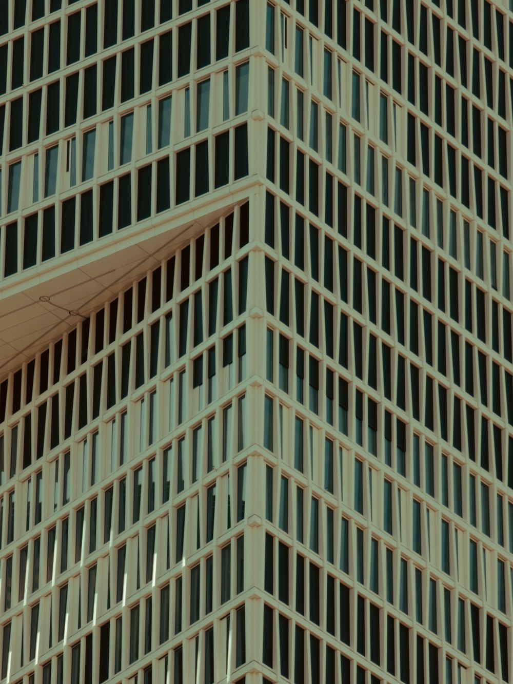 a close up of a very tall building with many windows