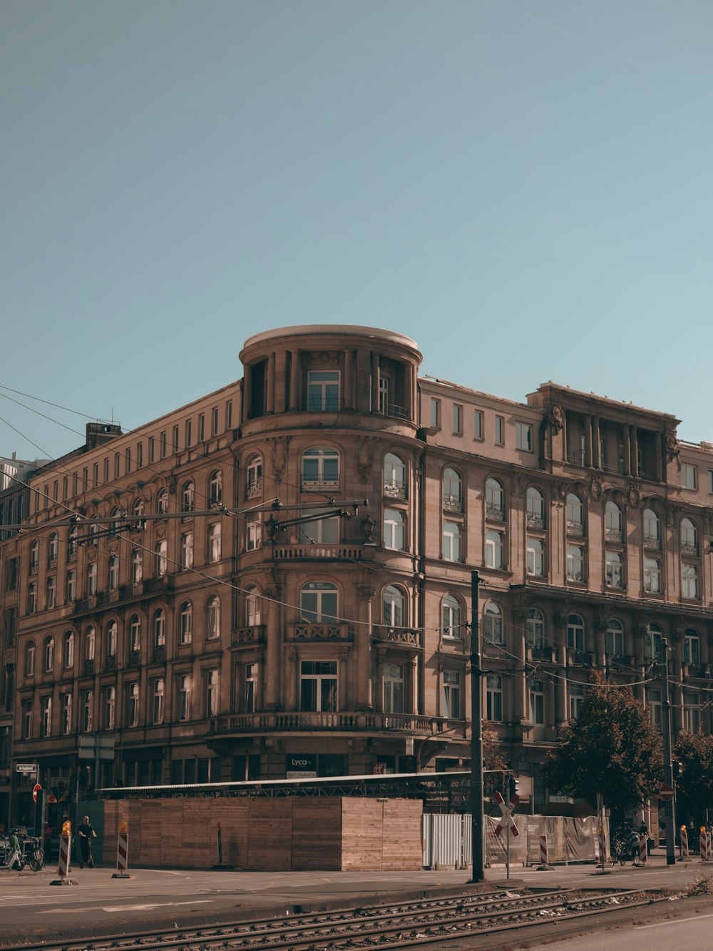 a large brown building sitting on the side of a road