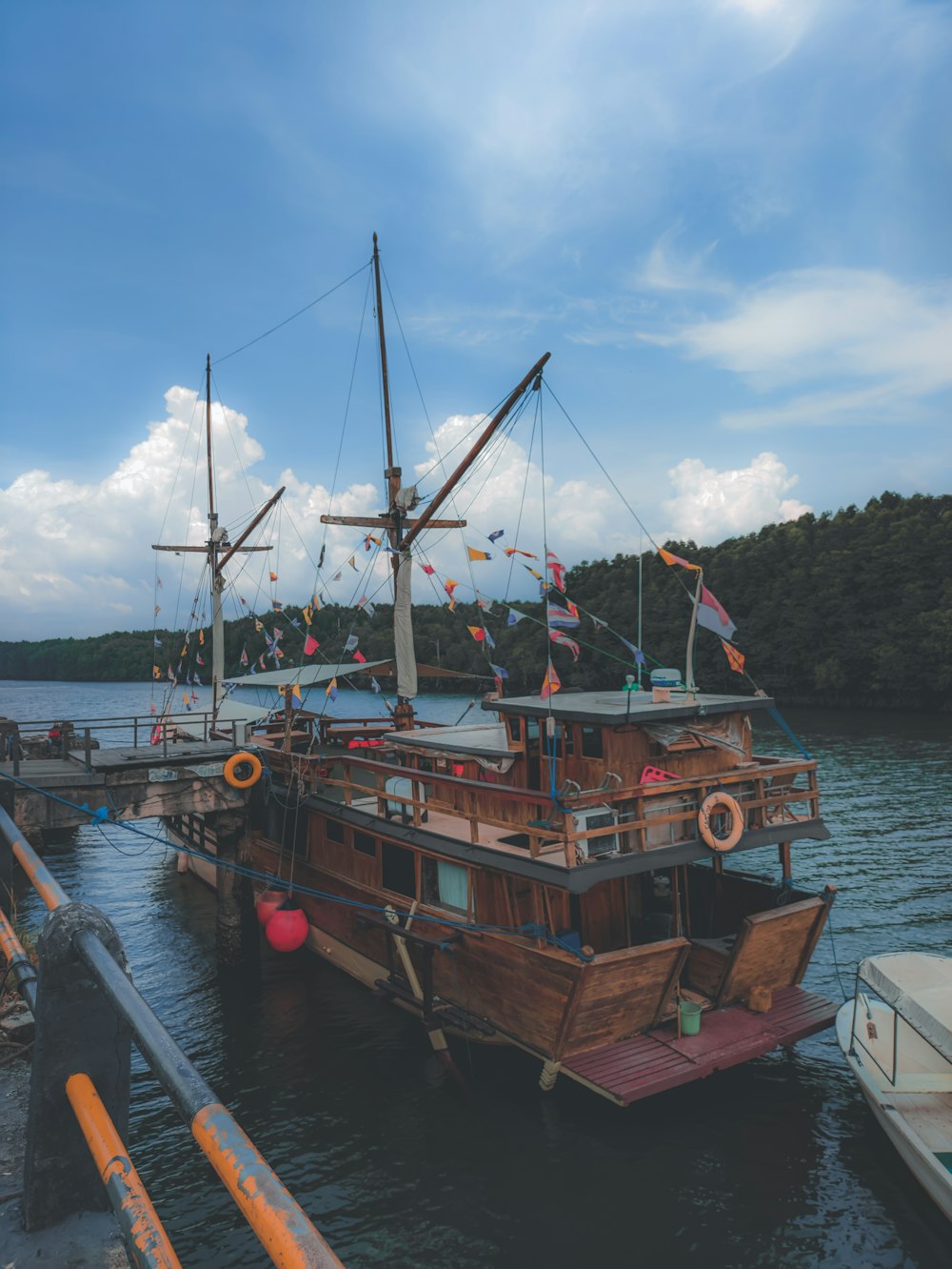 a boat docked at a dock with other boats