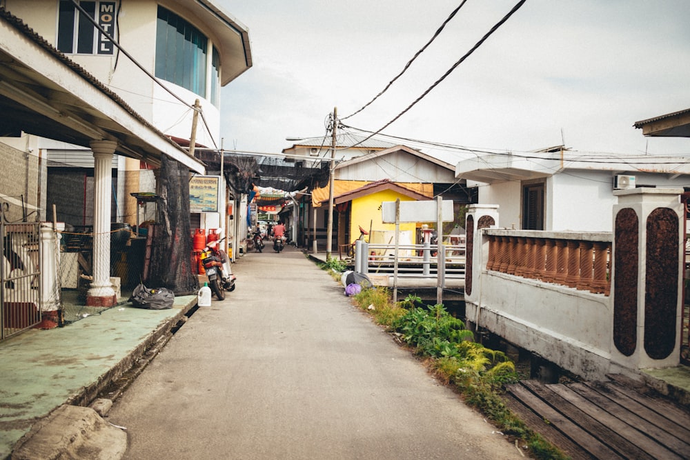 a narrow street lined with houses on both sides