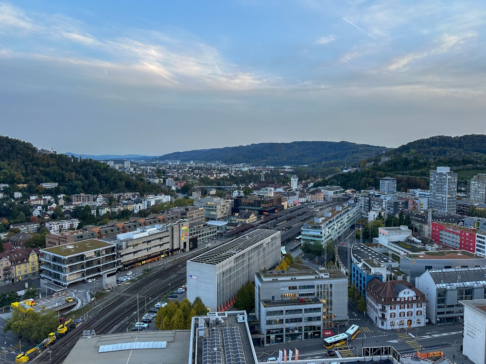 an aerial view of a city with a train on the tracks