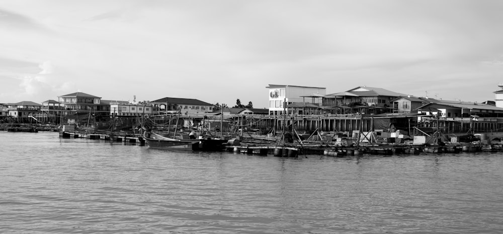 a black and white photo of a harbor with boats