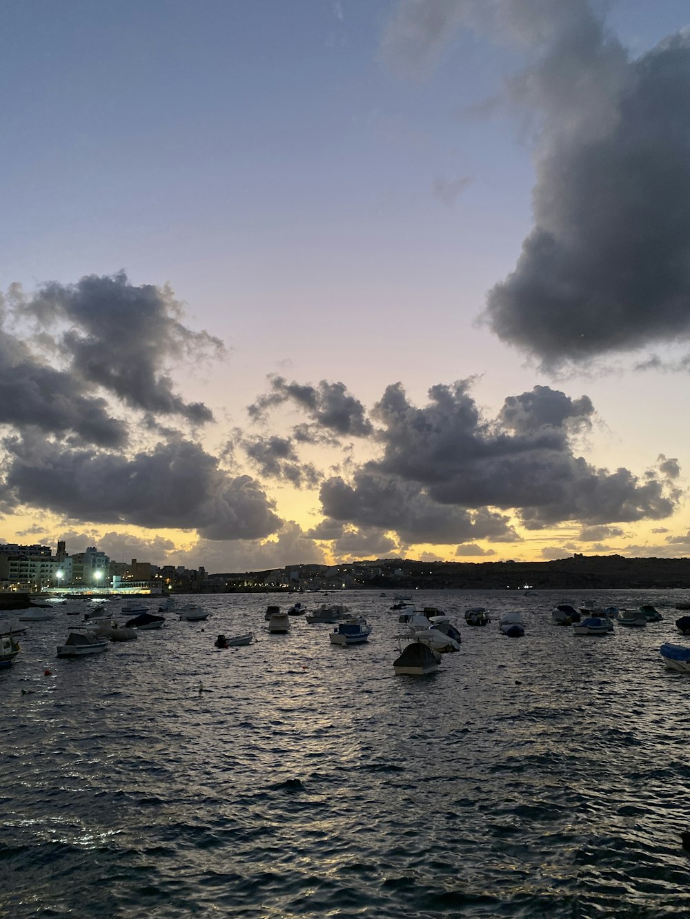 a group of boats floating on top of a body of water