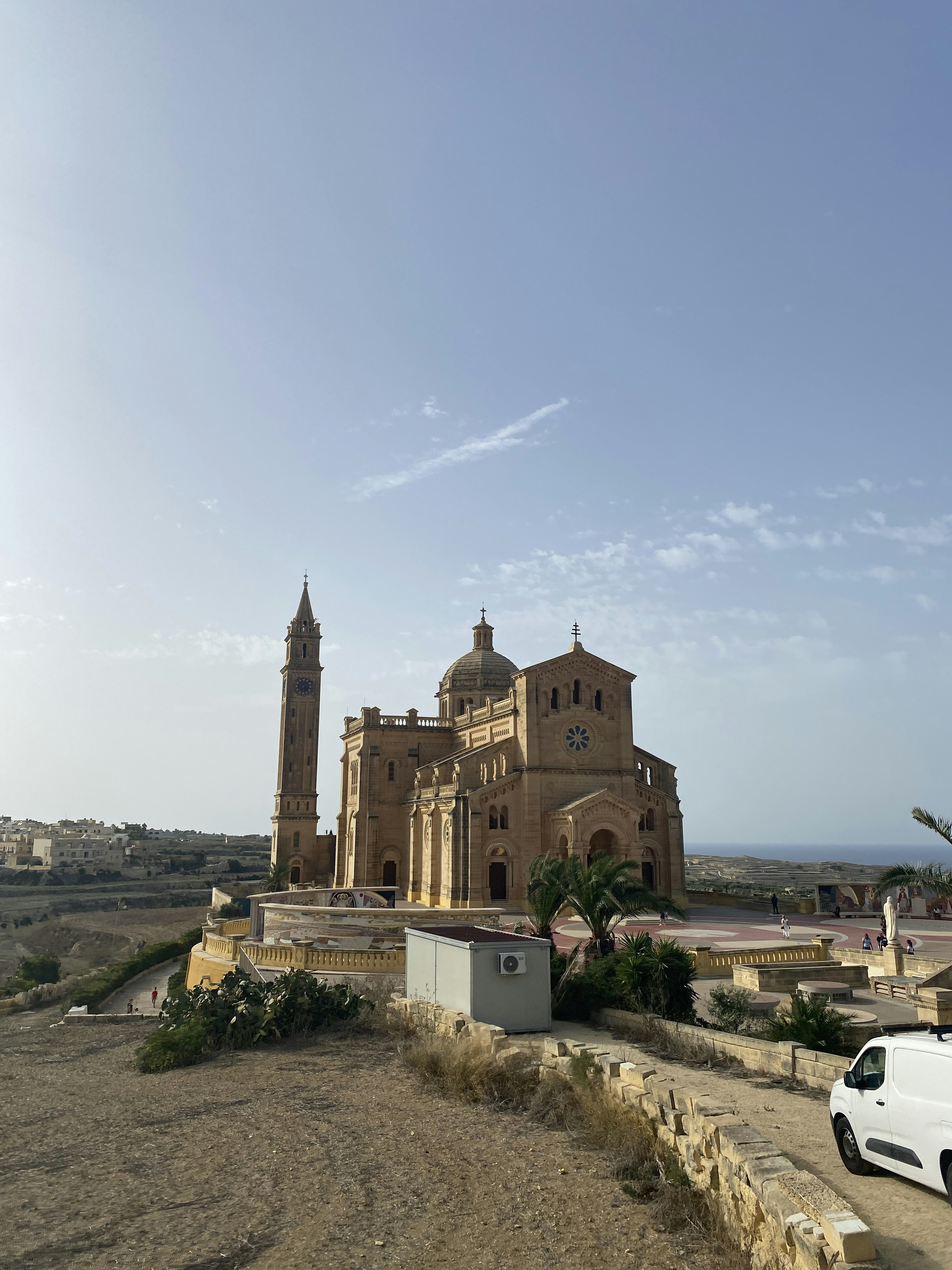 a white van is parked in front of a church
