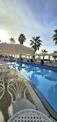 A serene poolside scene with soft lighting and elegant outdoor furniture, evoking a sense of calm and exclusivity.