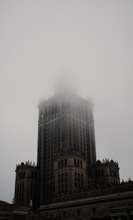 A fog rolling over the historic downtown square, with faint outlines of Victorian architecture.