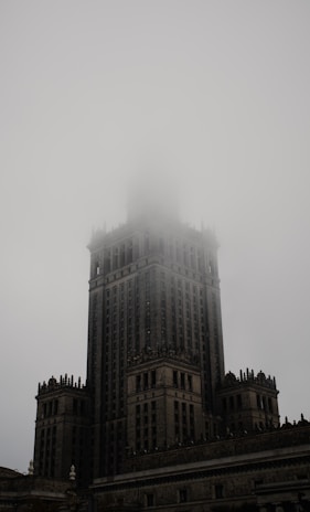 A fog rolling over the historic downtown square, with faint outlines of Victorian architecture.