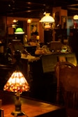 A dimly lit antique shop with various vintage objects, including lamps with stained glass and colored shades. Shelves are filled with decorative items and furniture, creating a nostalgic and cozy atmosphere.