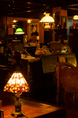 A cozy, well-lit antique shop corner showcasing vintage furniture and classic paintings.