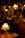 A dimly lit antique shop with various vintage objects, including lamps with stained glass and colored shades. Shelves are filled with decorative items and furniture, creating a nostalgic and cozy atmosphere.
