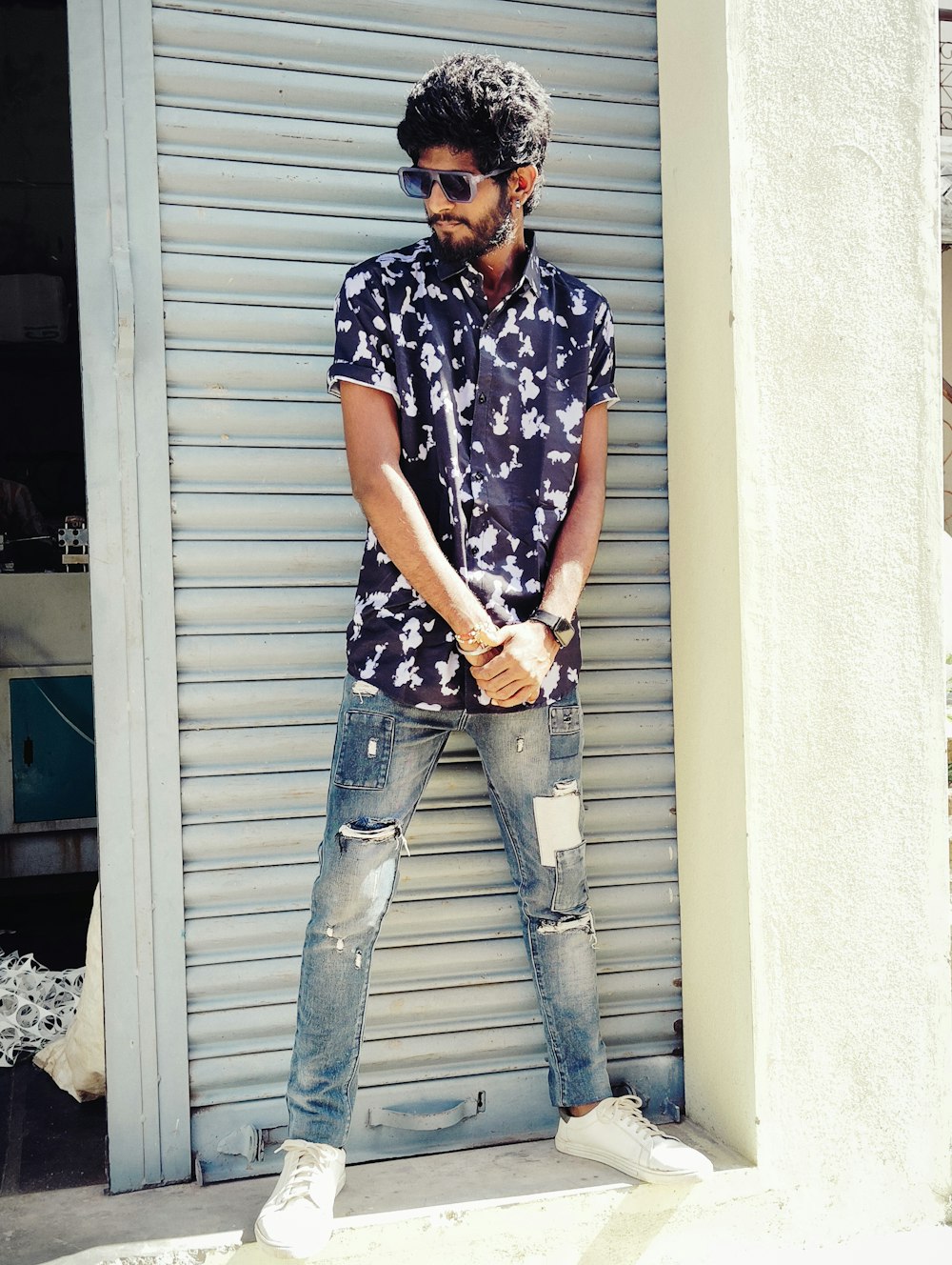 a man standing in front of a garage door