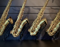 a row of saxophones lined up against a wall