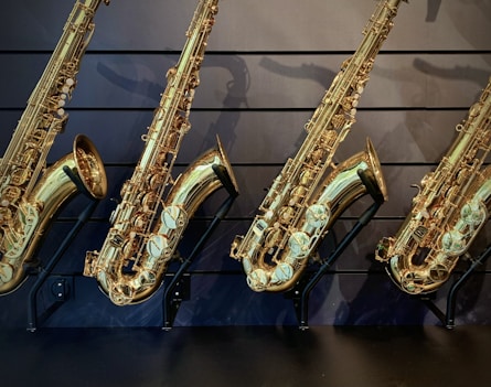 a row of saxophones lined up against a wall