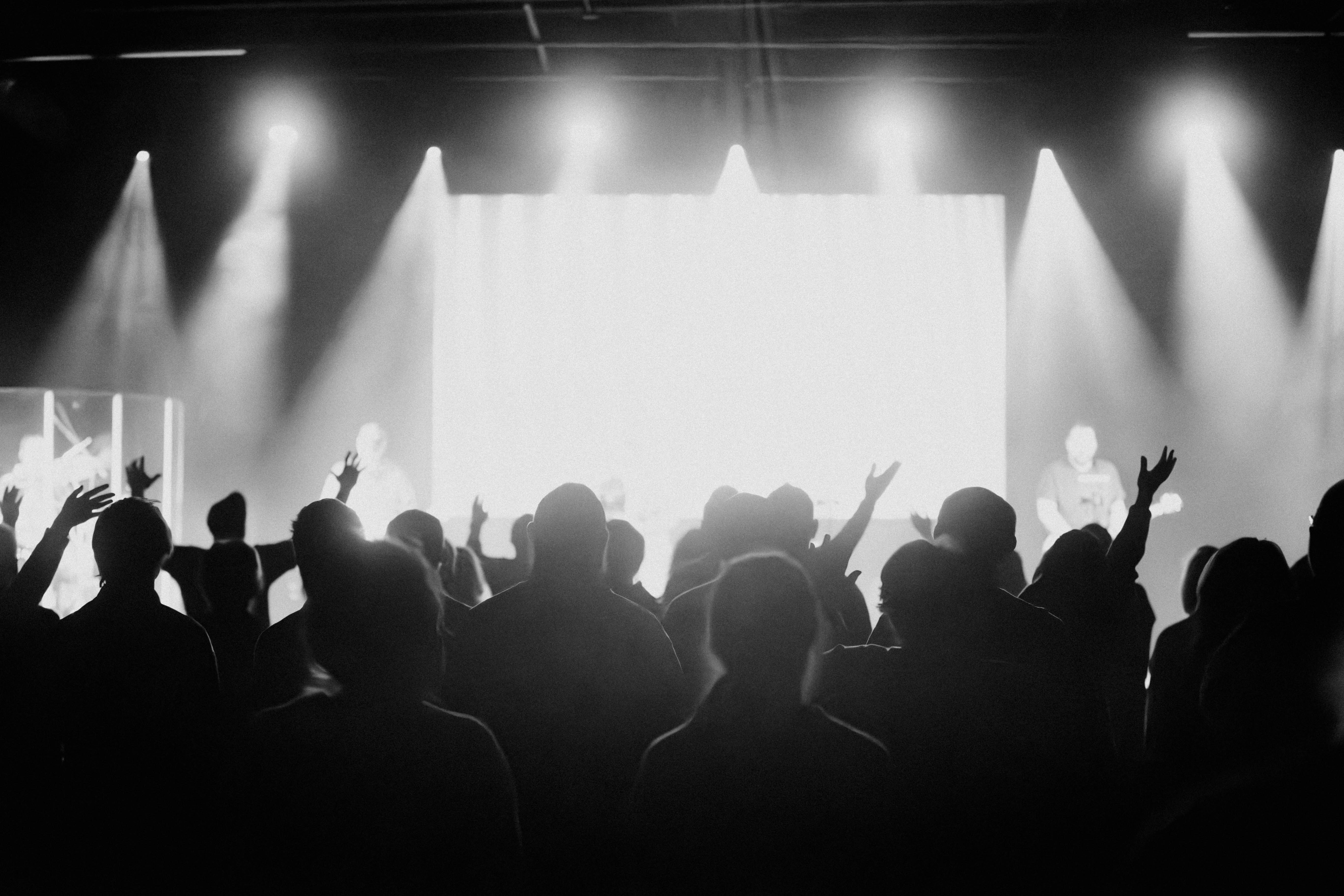 a group of people standing in front of a stage