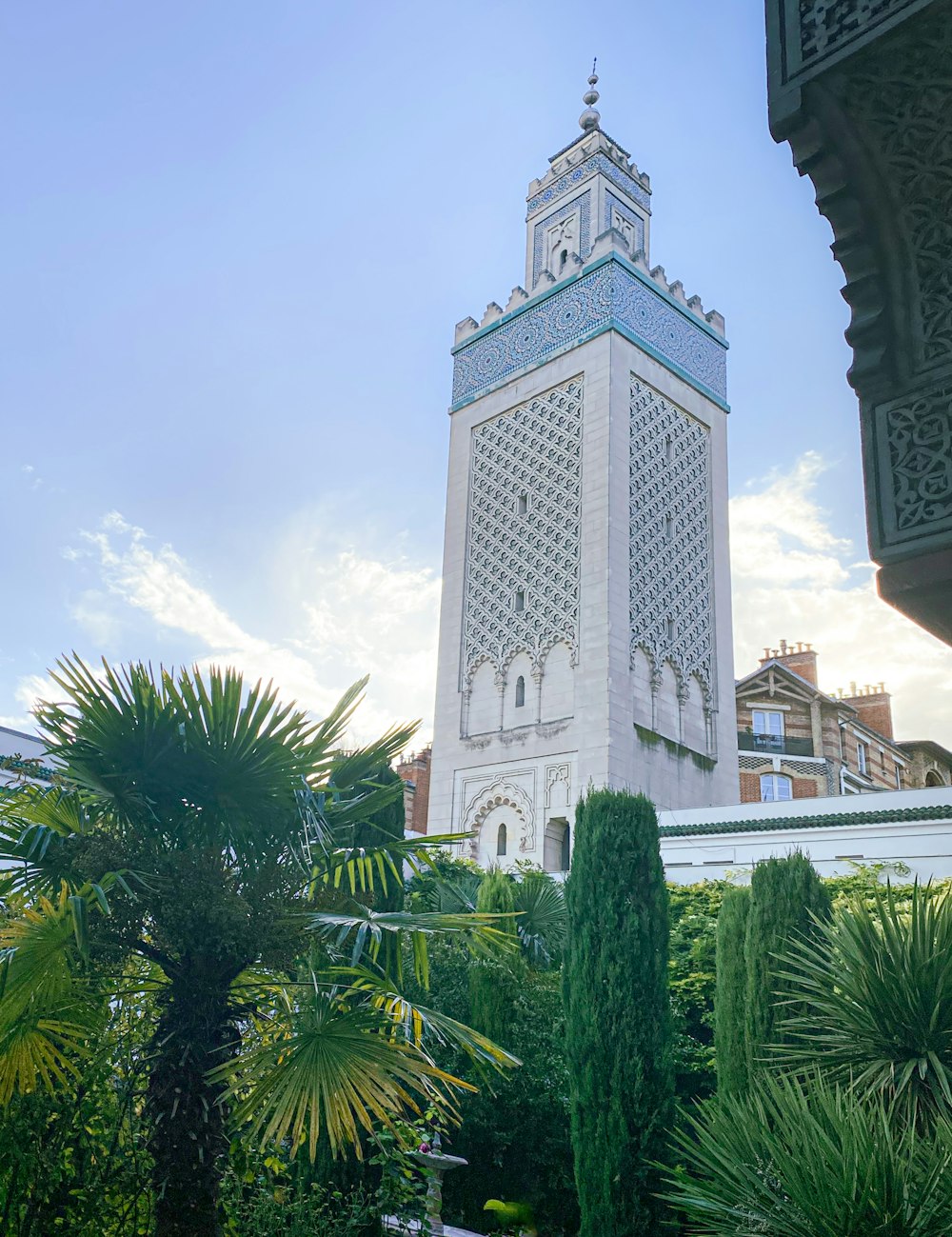 a tall white tower with a clock on it's side