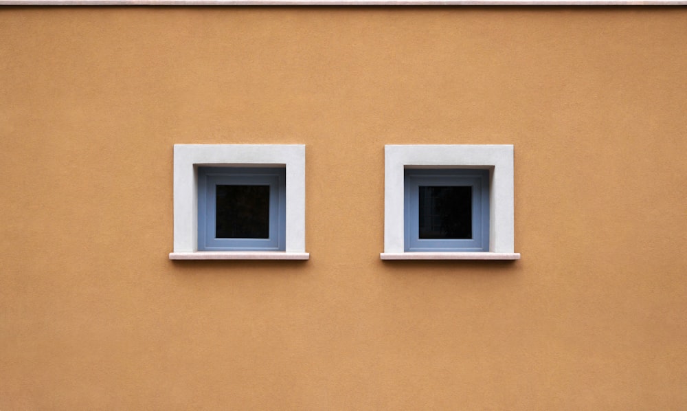 two windows on the side of a building