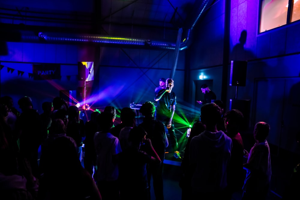 a group of people standing around a room