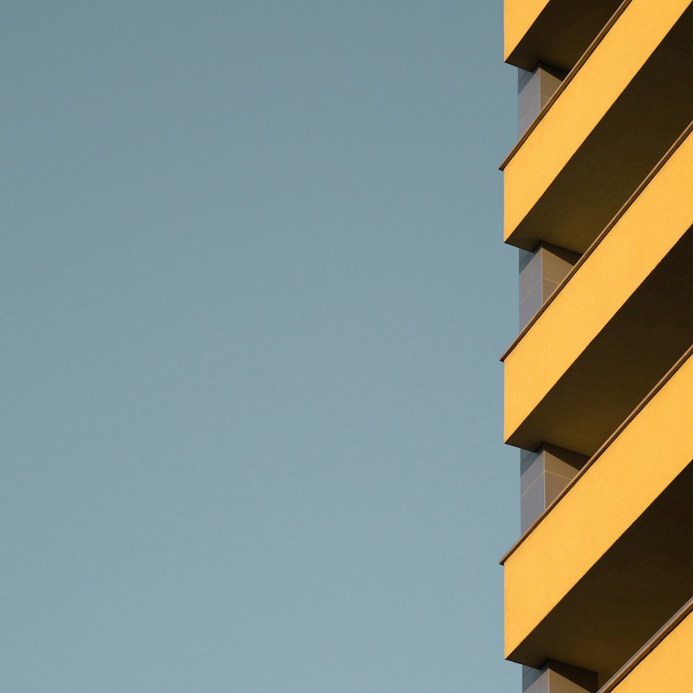 an airplane flying in the sky over a building