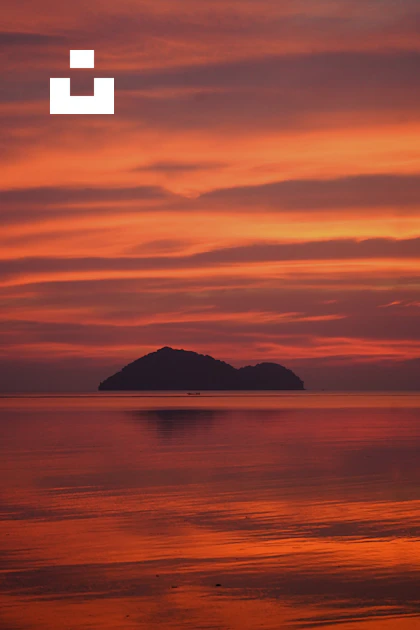 Small Sunset A sunset with a small island in the distance photo – Free Sunset beach ...