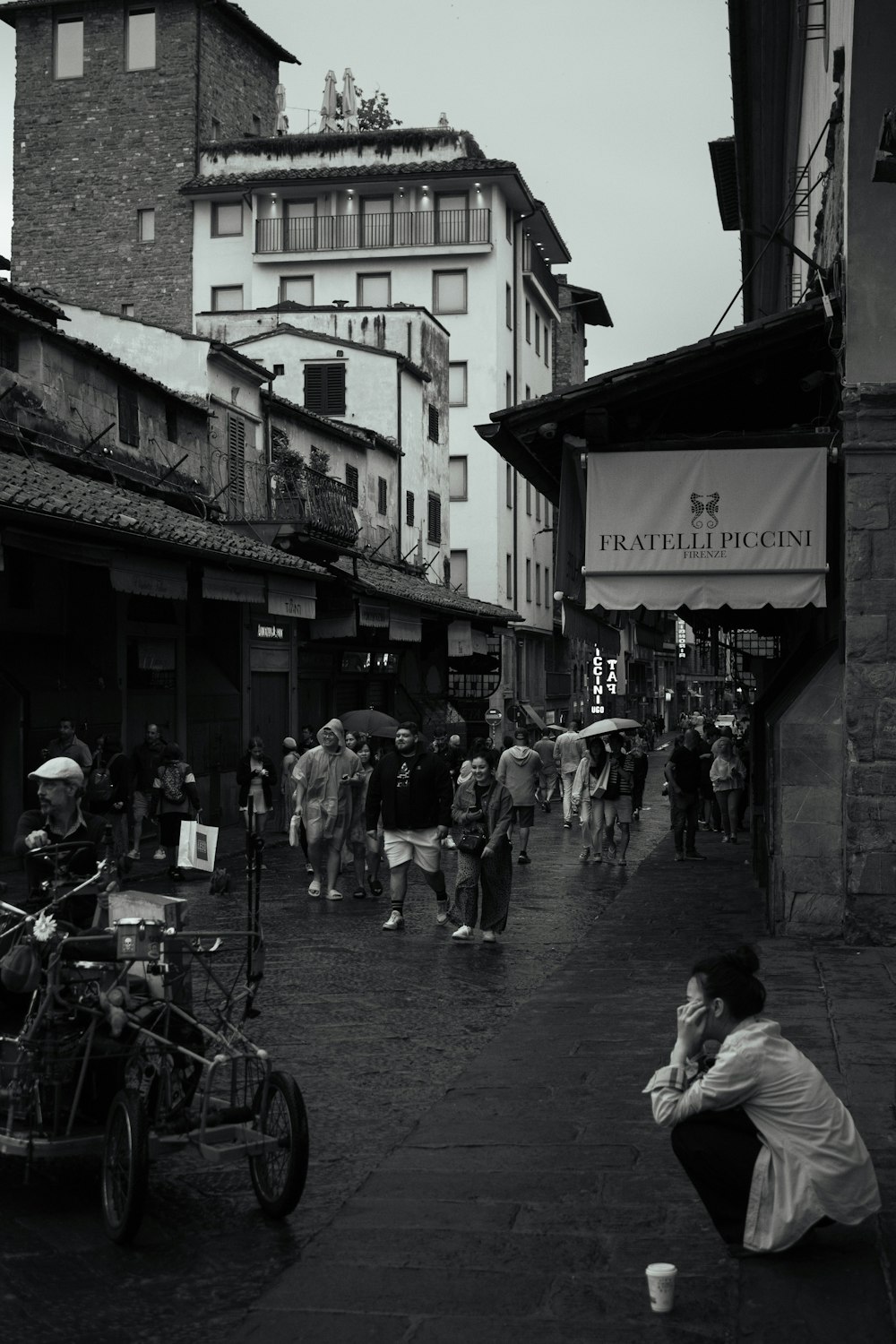 a black and white photo of a person sitting on the ground