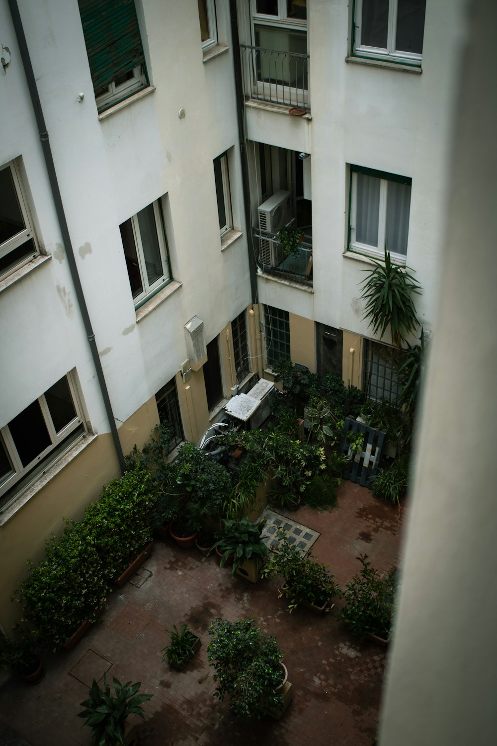 an aerial view of a courtyard with potted plants