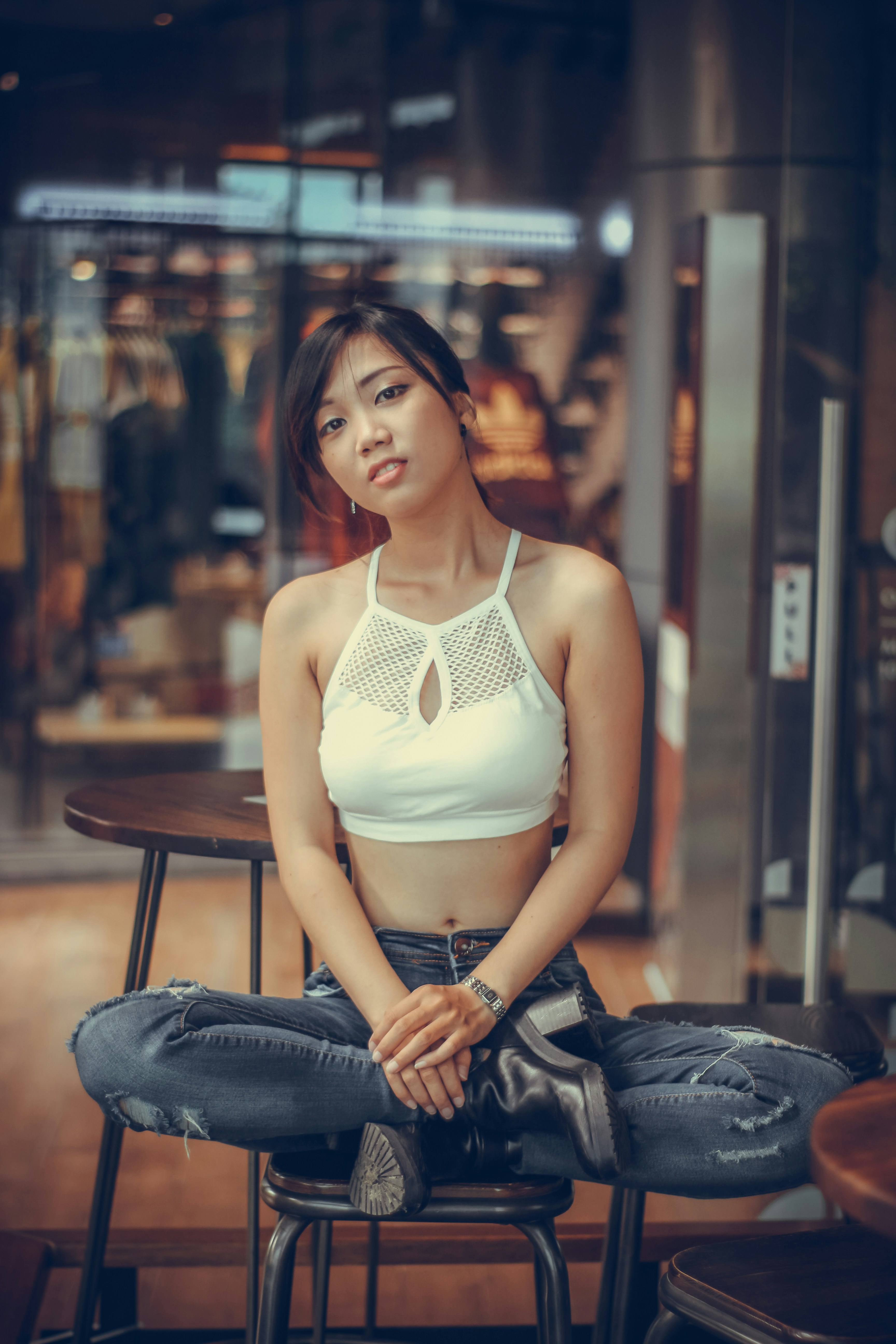 a woman sitting on top of a wooden chair