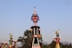 a group of colorfully painted statues in front of a blue sky