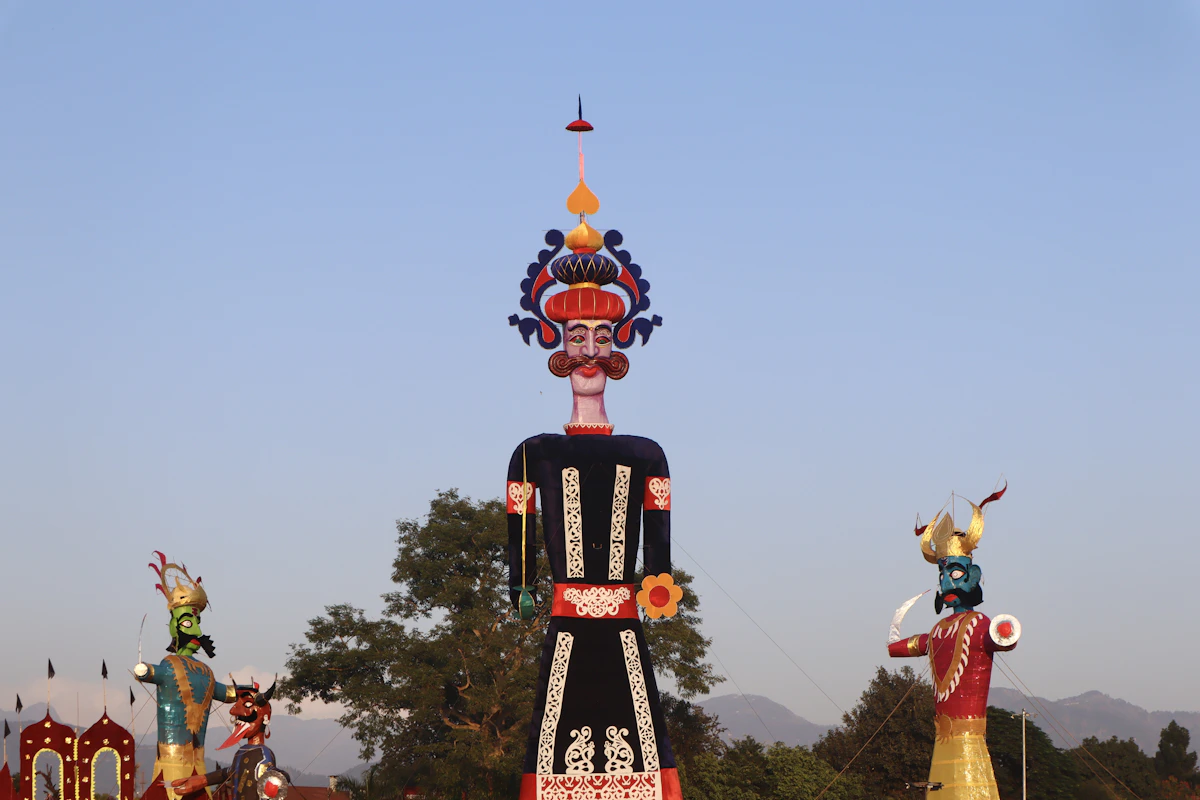 A tall Ravana effigy against the sky, before the evening burning at Dussehra