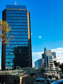 a very tall building sitting next to a bridge