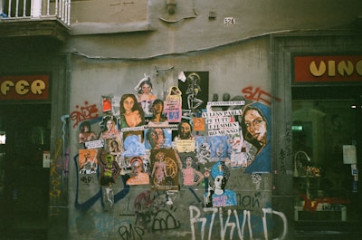 Colorful street art celebrating queer identities on a brick wall in an urban neighborhood.