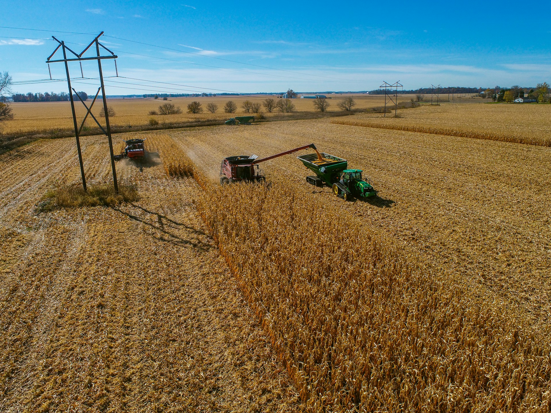 a tractor is driving through a field of wheat
