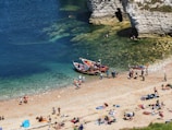 A vibrant community gathering on a sunny beach.
