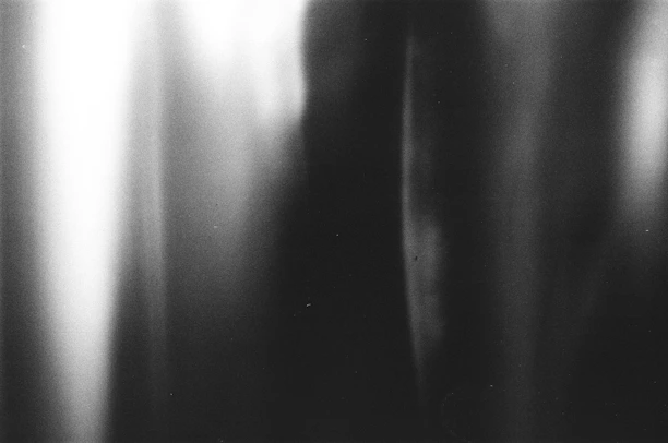 Stylish black and white abstract background with soft shadows and smooth gradients.