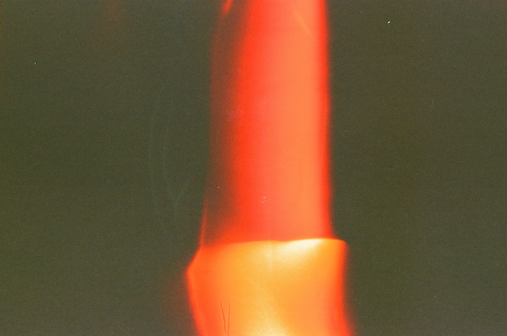 a close up of a red object with a blurry background