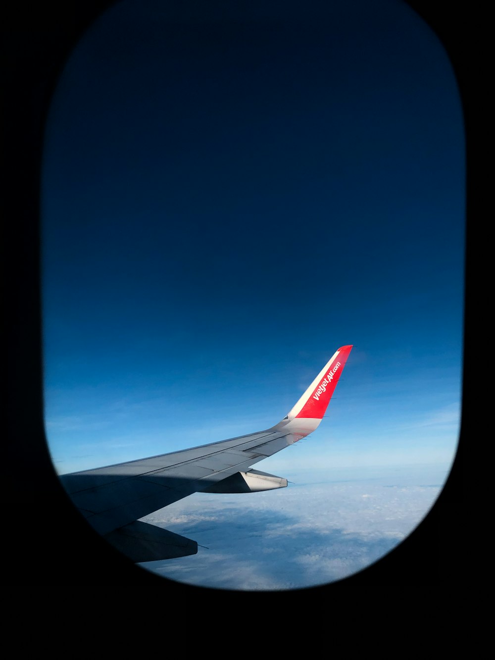 a view of the wing of an airplane in the sky