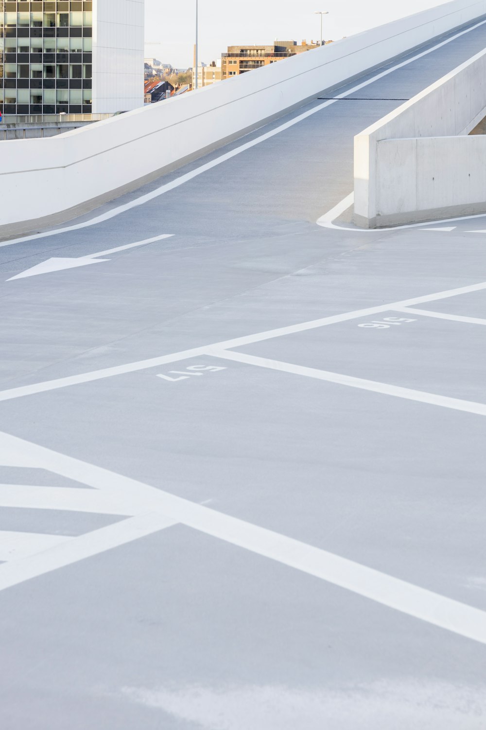 a man riding a skateboard down the middle of a parking lot