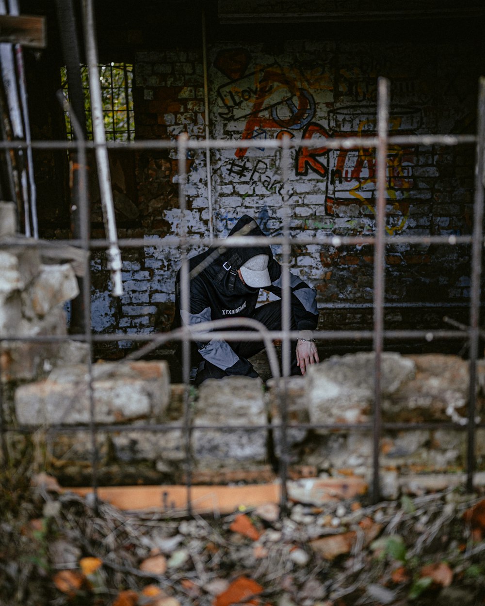 a person in a black jacket sitting on a bench