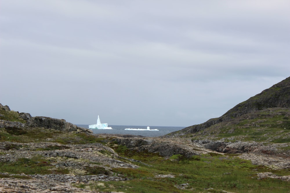 a large iceberg floating in the middle of the ocean